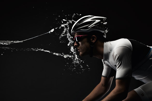 Water makes the cyclist, intense water splashing cyclist in dark. cyclistmag UK